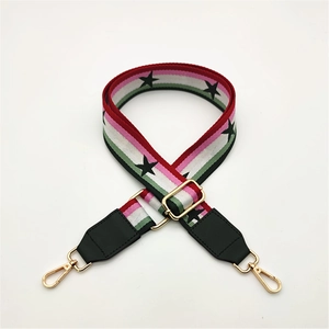Adjustable woven strap with star patterns and gold-tone metal lobster clasps for bags