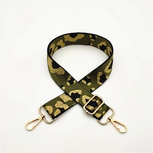 Detail of adjustable leopard print bag strap with golden metal swivel hooks and buckles