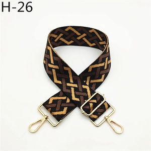 Detailed view of adjustable geometric pattern shoulder strap with gold lobster clasps