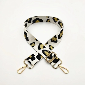 Adjustable leopard print bag strap with golden metal lobster clasps and thick canvas texture