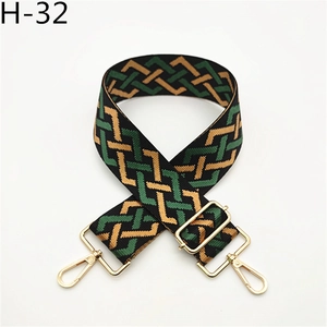 Detail view of woven geometric bag strap H-32 with golden metal lobster clasps and buckle