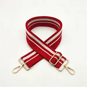 Detail of red and white striped bag strap with light gold metal clips in style 4