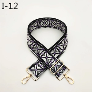 Detail of adjustable snowflake patterned bag strap with gold metal lobster clasps