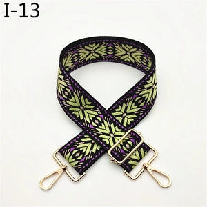 Detail of bohemian jacquard bag strap with snowflake pattern and gold metal hooks