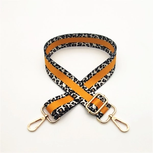 Adjustable leopard print canvas shoulder strap with orange accents and gold metal hooks