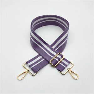 Detail of adjustable purple and white striped bag strap with gold metal lobster clasps