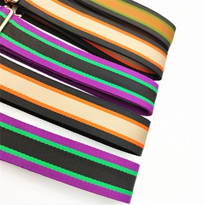 Close-up of colorful striped woven replacement shoulder straps with gold metal clasps
