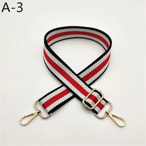Detail of adjustable red white and black striped woven strap with gold metal lobster clasps