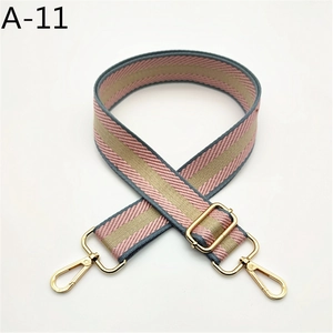 Detail of adjustable pink and blue striped woven strap with gold metal lobster clasps