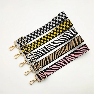 Adjustable crossbody shoulder straps in colorful checkered and zebra patterns with gold hooks