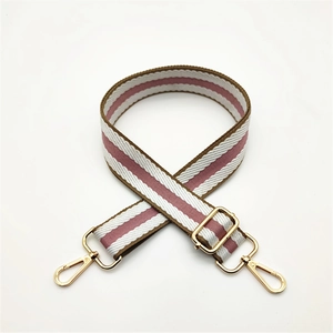 Adjustable striped nylon bag strap with gold metal buckles in pink, white, and brown
