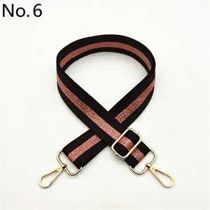 Detail view of adjustable black and rose gold glitter striped strap with gold metal hooks