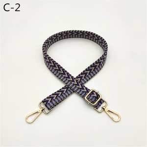 Detail of vintage geometric woven bag strap with light gold metal lobster clasps
