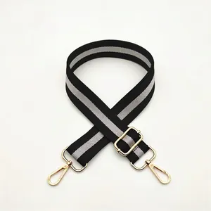 Adjustable black and grey striped shoulder strap with gold-tone metal hooks and buckles