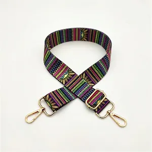 Adjustable colorful woven bag strap with geometric floral patterns and gold hardware