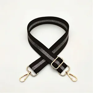 Close-up of No. 9 black and grey striped adjustable fabric bag strap with gold metal buckles