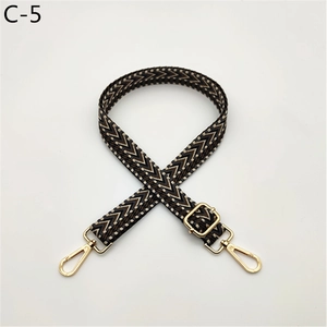 Detail of adjustable chevron strap with golden swivel hooks and thick cotton weave