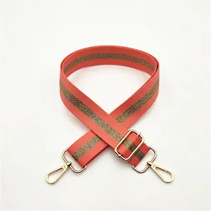 Adjustable coral orange shoulder strap with gold metallic thread and lobster clasps