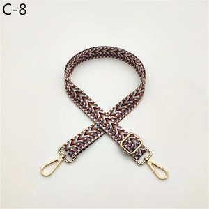 Close-up of geometric ethnic pattern bag strap with light gold metal swivel hooks