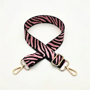 Detail of pink zebra print replacement bag strap with golden lobster clasps and slider