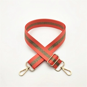Adjustable coral orange fabric bag strap with metallic gold thread and gold hooks