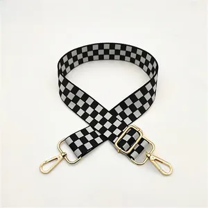 Adjustable black and white checkered bag strap with gold metal hooks for crossbody bags