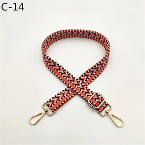 Close-up of colorful ethnic geometric woven strap with golden metal lobster clasps
