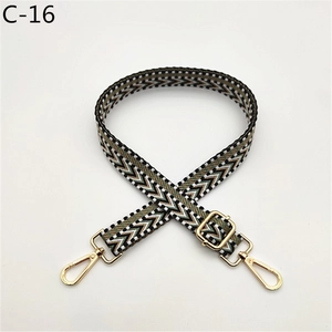 Detail of adjustable woven bag strap with geometric V-pattern and gold-tone lobster clasps