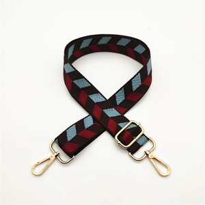 Detail of adjustable woven canvas bag strap with colorful geometric diamond leaf patterns