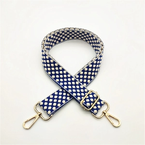 Adjustable blue and white polka dot woven cotton shoulder strap with gold metal buckles
