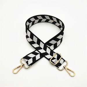 Adjustable black and white chevron patterned knit shoulder strap with gold metal hooks