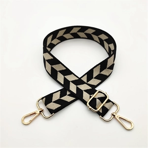 Detail of adjustable woven shoulder strap with black and white V-shape geometric pattern