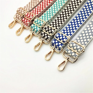 Detailed view of multiple polka dot adjustable shoulder straps with gold hardware buckles