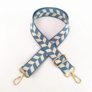 Close-up of Morandi blue and white woven shoulder strap with gold metal hooks