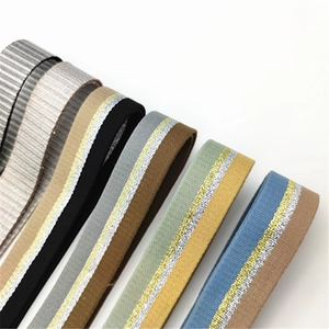 Detail of adjustable striped bag straps with gold and silver metallic thread embroidery