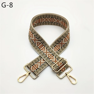 Close-up of bohemian geometric patterns on thick adjustable bag strap with gold hooks
