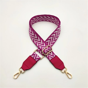 Detail of purple PU leather reinforced ends with golden metal hooks on woven strap