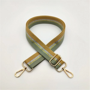 Adjustable striped woven shoulder strap with mustard yellow, green, and gold hardware