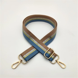 Adjustable brown and blue striped bag strap with gold metal hooks on white background