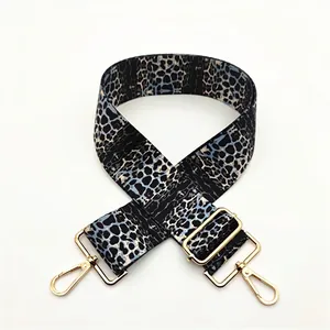 Detail of leopard print wide adjustable shoulder strap with shiny gold lobster clasps