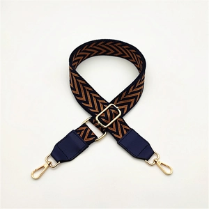 Detail of adjustable PU leather bag strap with navy and orange herringbone weave pattern
