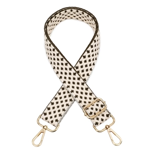 Detail of adjustable woven bag strap with brown star pattern and gold metal hooks
