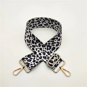 Close-up of adjustable purple leopard print bag strap with golden metal swivel snap hooks