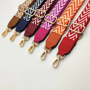 Close-up of adjustable PU leather strap with chevron pattern and gold metal hooks