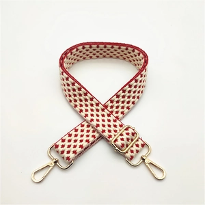 Adjustable woven shoulder strap for bags featuring red and white geometric patterns