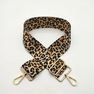 Detailed view of adjustable leopard print strap with golden lobster clasps and metal buckle