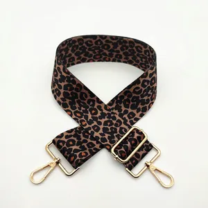 Close-up of adjustable leopard print bag strap with polished gold lobster clasps