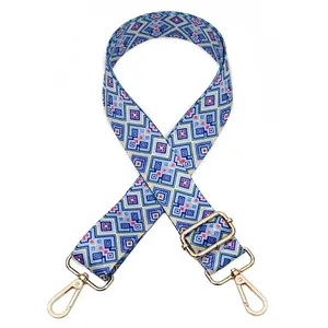 Detail of adjustable geometric ethnic pattern strap with gold metal buckles for bags