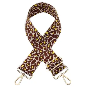 Close-up of a wide leopard print bag strap with high-quality light gold metal hardware