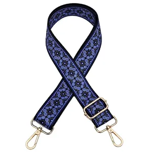 Detail view of ethnic blue swirl pattern nylon bag strap No. 20 with gold hardware hooks
